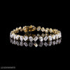 Oval and emerald cut diamond tennis bracelet in yellow gold by Luxeornate