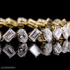 Oval and emerald cut diamond tennis bracelet in yellow gold by Luxeornate