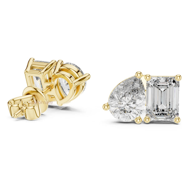 Toi et moi diamond stud earrings with pear and emerald cut diamonds in yellow gold