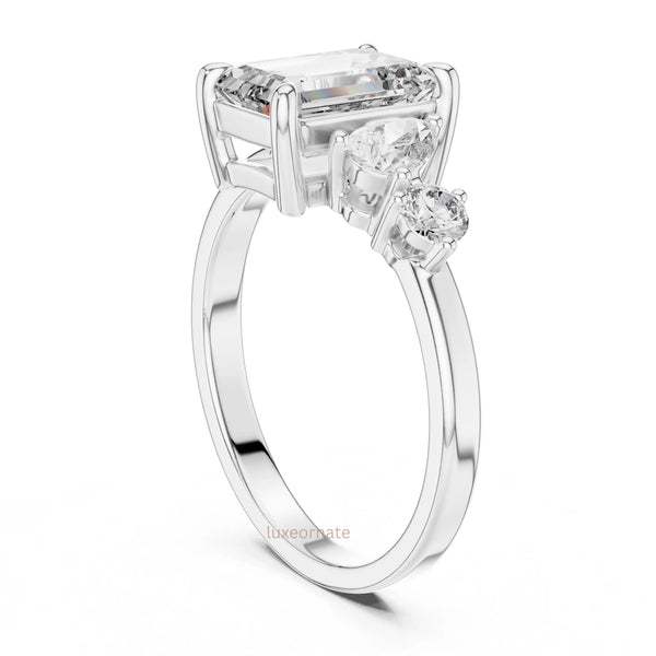 emerald cut diamond with one side two stone ring