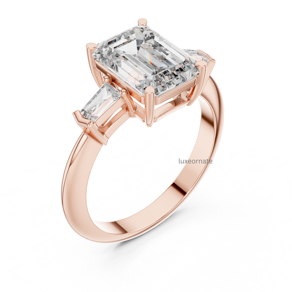 Angled rose gold emerald cut diamond engagement ring with trapezoid side stones, lab grown luxury bridal ring.