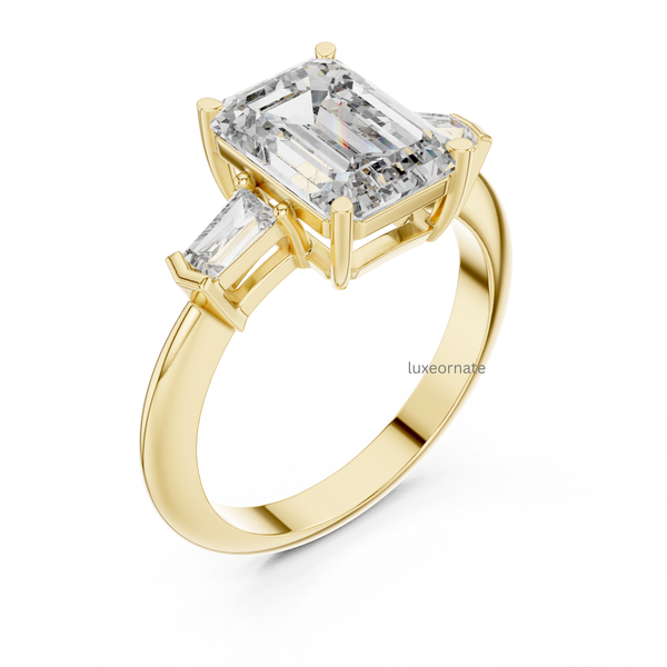 Angled yellow gold emerald cut three stone diamond engagement ring with trapezoid side diamonds, fine bridal jewelry.