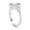 Angled white gold emerald cut diamond ring with trapezoid side stones, three stone lab grown engagement ring, luxury statement jewelry.
