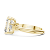 Side view yellow gold emerald cut diamond ring with trapezoid side stones, prong setting lab grown engagement ring, luxury fine jewelry.