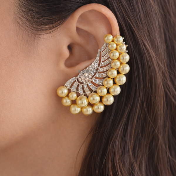 Golden pearl and diamond ear cuff earring on ear, luxury statement bridal jewelry for women
