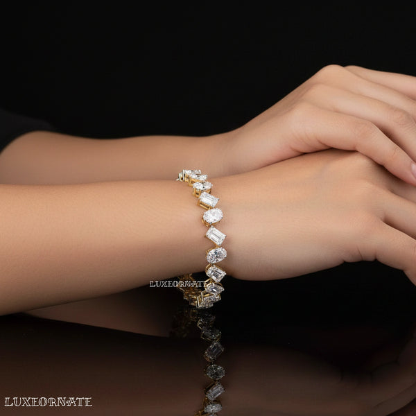 Oval and emerald cut diamond tennis bracelet in yellow gold by Luxeornate