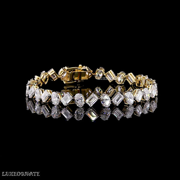 Oval and emerald cut diamond tennis bracelet in yellow gold by Luxeornate