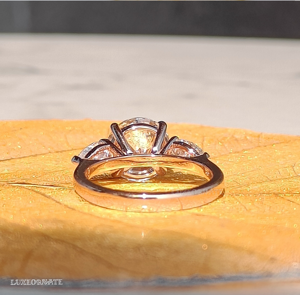 round cut three stone diamond engagement ring with pear side diamonds in white gold bridal jewelry, gifting jewelry.