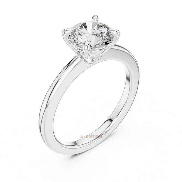Timeless diamond engagement ring with four prong setting and polished gold band