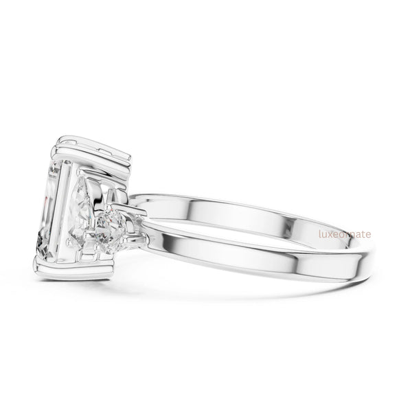 emerald cut diamond with one side two stone ring