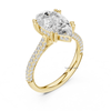Angled view of pear cut diamond engagement ring in yellow gold with double pavé band and six prongs.