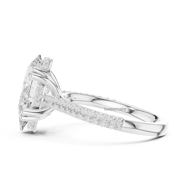 White gold pear cut diamond engagement ring side view with pavé diamonds and elevated gallery.