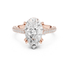 Pear cut diamond engagement ring in rose gold with double pavé band and elegant claw prongs.