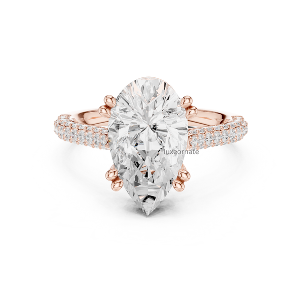 Pear cut diamond engagement ring in rose gold with double pavé band and elegant claw prongs.