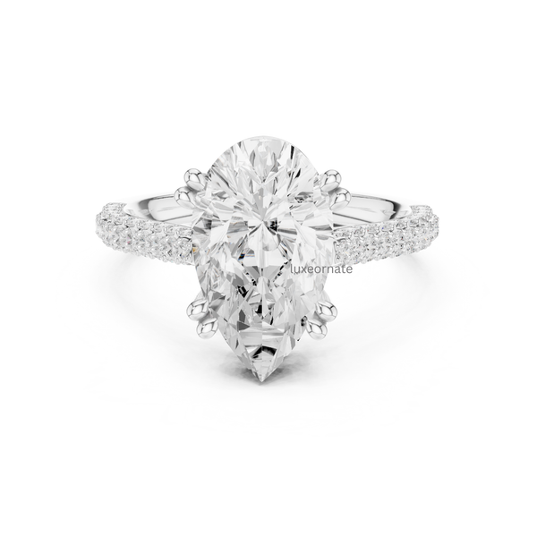 Pear shaped diamond engagement ring in white gold with split pavé shank and secure prong setting.