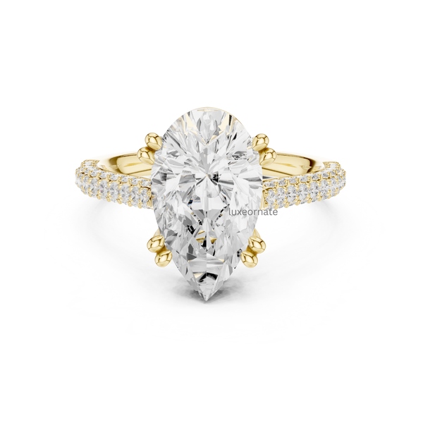 Pear cut diamond engagement ring in yellow gold with double pavé band and six prong setting, front view.