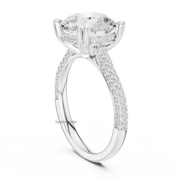 White gold round diamond engagement ring side angle showing hidden halo, split band, and pavé diamonds.
