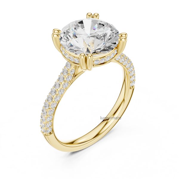 Angled view of yellow gold round diamond solitaire ring with split pavé band and six prong setting.