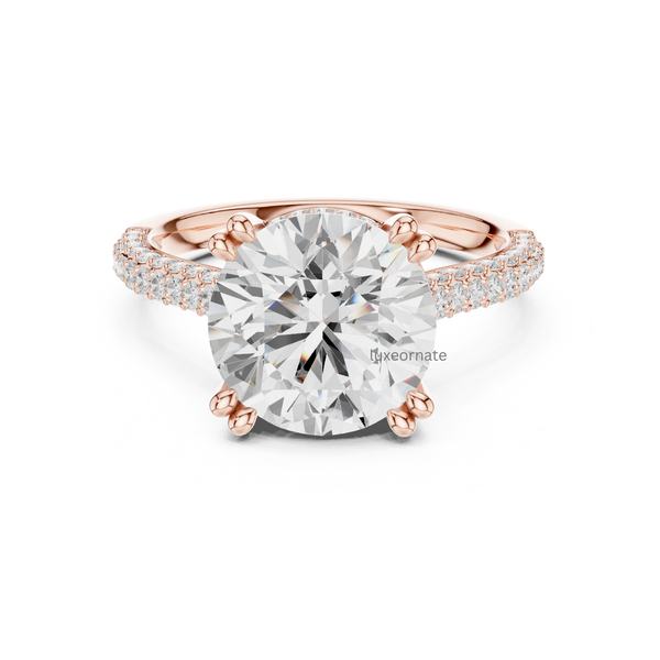 Rose gold round diamond solitaire engagement ring with double pavé band and secure claw prongs.