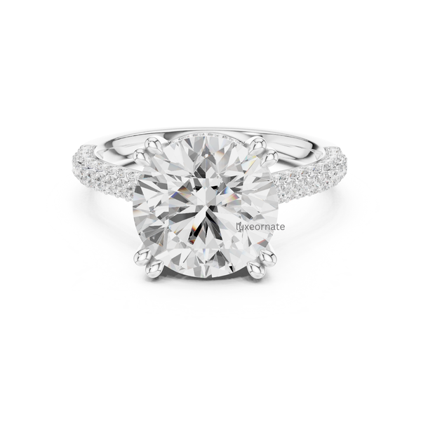 Round brilliant diamond engagement ring in white gold with split pavé shank and six prong setting.