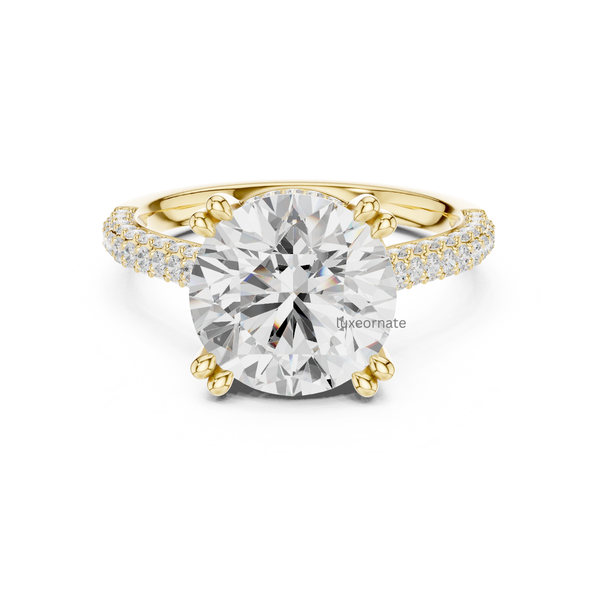 Round cut diamond engagement ring in yellow gold with split pavé band and six prong solitaire setting.