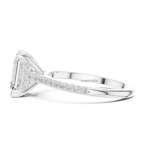 Side profile of white gold emerald cut diamond ring highlighting pavé-set shank and prong structure