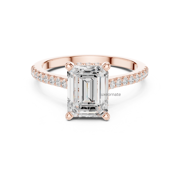 Rose gold emerald cut diamond engagement ring with delicate pavé band, front view