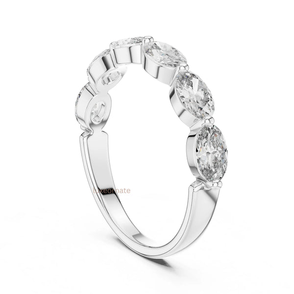 Close up view of oval diamond band ring in white gold highlighting fine craftsmanship and sparkling diamonds