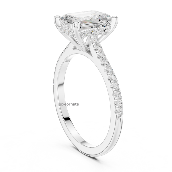 Detailed side view of white gold emerald cut diamond ringing highlighting pavé gallery and craftsmanship
