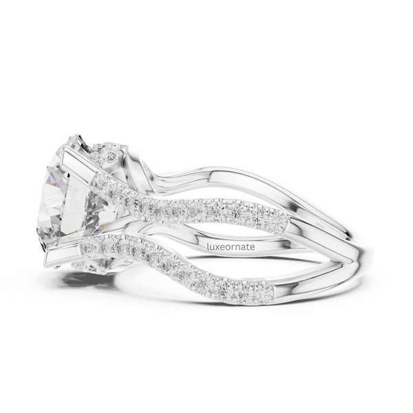 Side profile white gold round cut diamond ring with split shank and pavé diamonds.