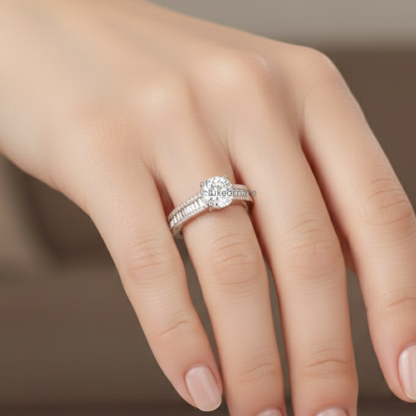 Round brilliant solitaire white gold engagement ring with double row pavé and baguette diamond band on woman’s hand, lab grown diamond bridal ring, luxury fine jewelry.