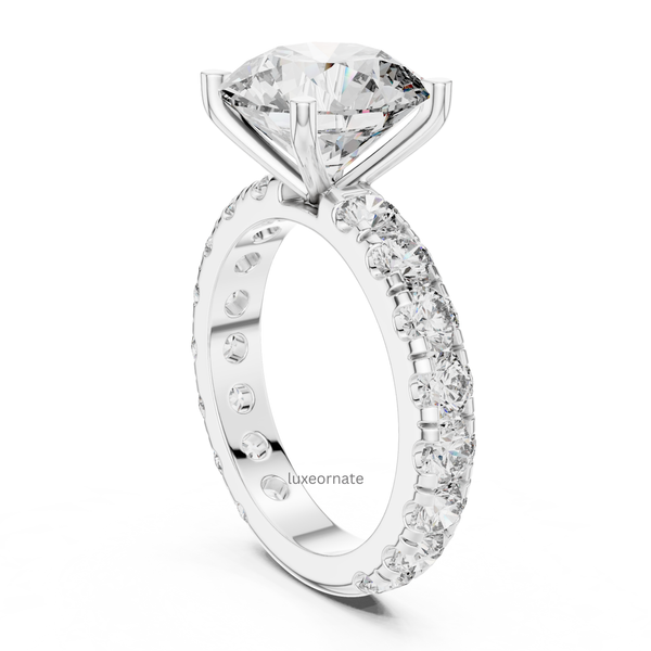 Angled white gold round brilliant diamond ring with pavé set band and cathedral prong setting, lab grown diamond engagement jewelry.