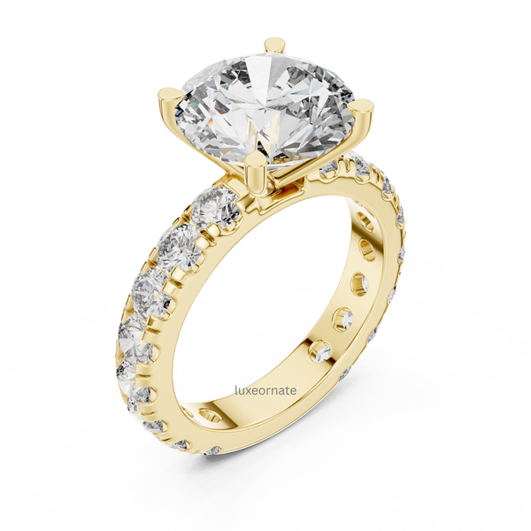 Angled yellow gold round solitaire engagement ring with pavé diamond half eternity band, lab grown diamond bridal ring, elegant luxury jewelry.