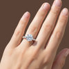 Round brilliant lab grown diamond engagement ring in rose gold with pavé diamond band on woman’s hand, four prong solitaire bridal ring, luxury fine jewelry.