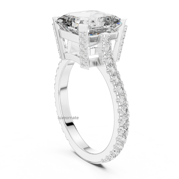 Angled white gold emerald cut diamond engagement ring with pavé shank and detailed gallery setting, rectangular lab grown diamond, modern luxury jewelry.