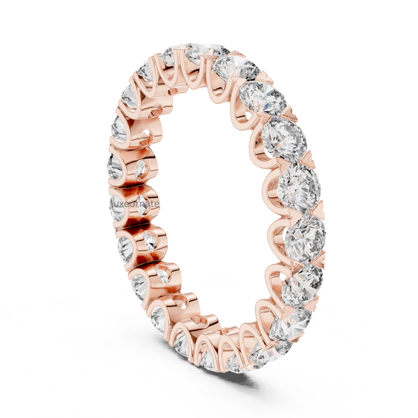 Angled rose gold round cut lab grown diamond eternity ring with shared prong full band design, luxury anniversary jewelry.