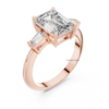 Angled rose gold emerald cut diamond engagement ring with trapezoid side stones, lab grown luxury bridal ring.