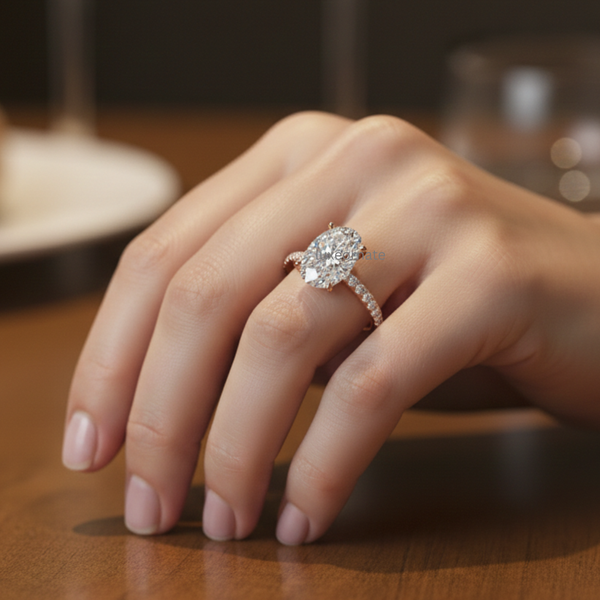 Model wearing oval cut diamond halo engagement ring with pavé band in rose gold.